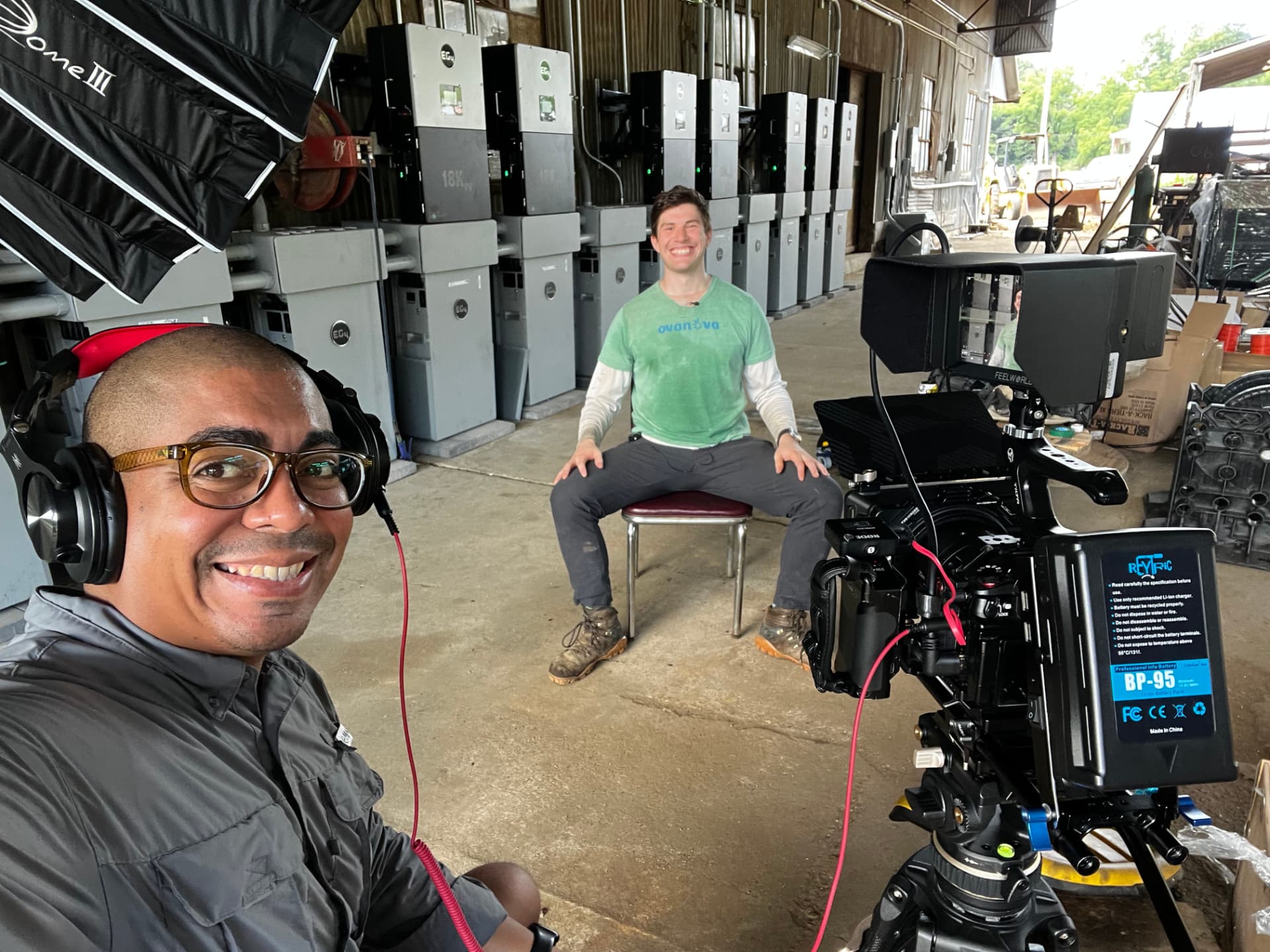 Luis filming an interview with an installer at a job site.